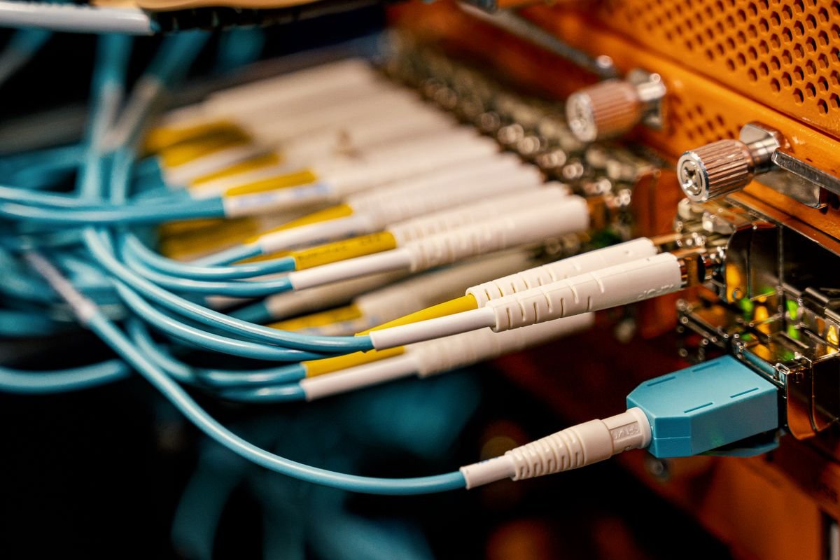 Fiber-optic cabling being installed in a network rack